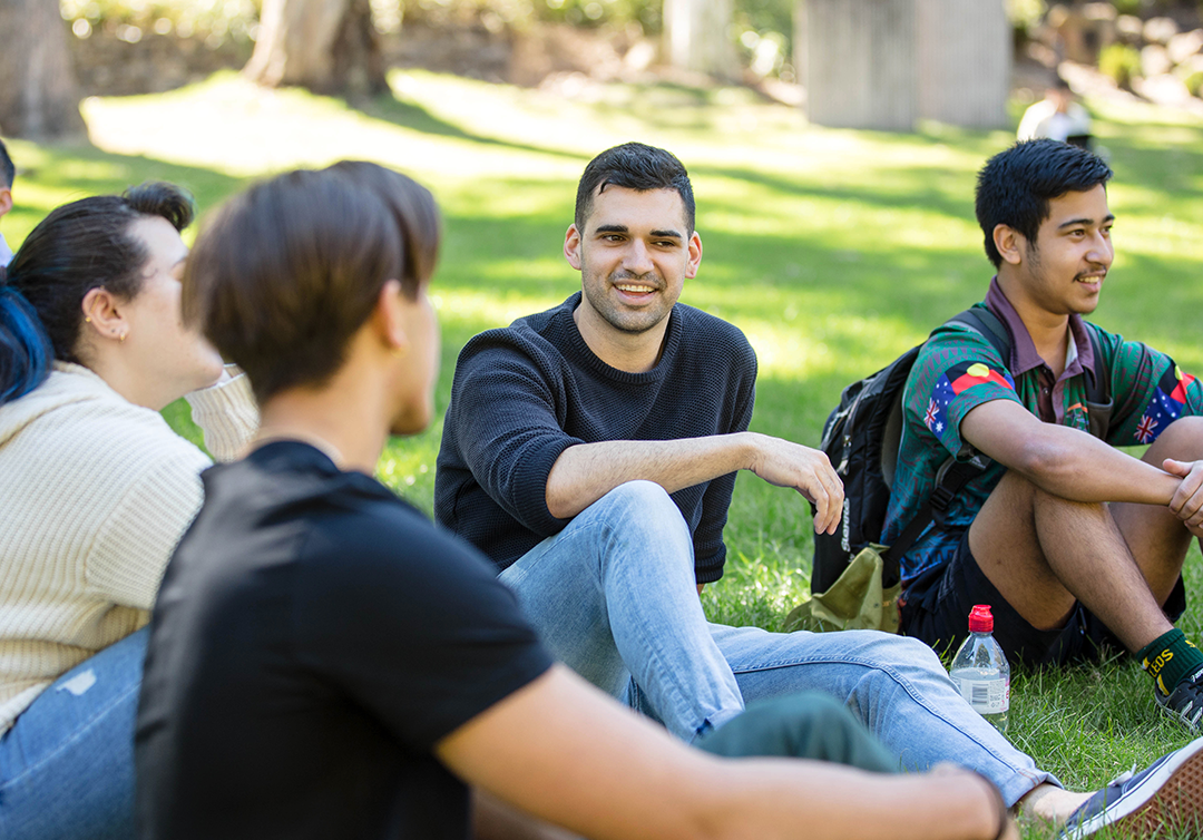 Students sitting outside at the St Lucia campus.