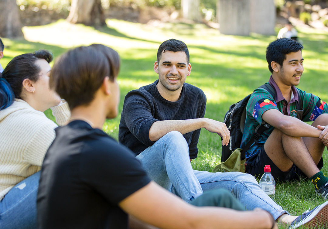 Students sitting outside at the St Lucia campus. 