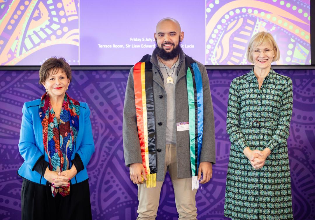 Elijah David standing with VC Prof Deborah Terry and DVCIE Prof Bronwyn