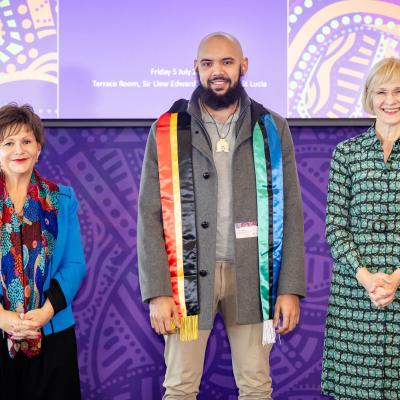 Elijah David standing with VC Prof Deborah Terry and DVCIE Prof Bronwyn