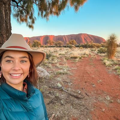 Young woman smiling in front of Uluru 