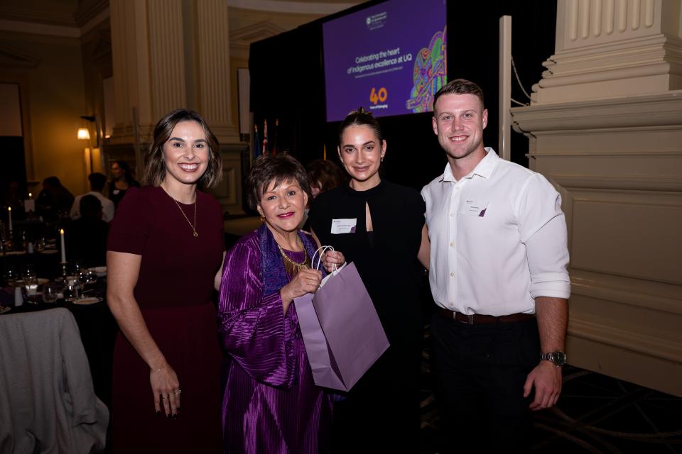 Four people standing together at the ATSIS Unit 40th Anniversary Dinner: Chenoa Masters, Professor Bronwyn Fredericks, Tachae Douglas-Miller, and her partner.