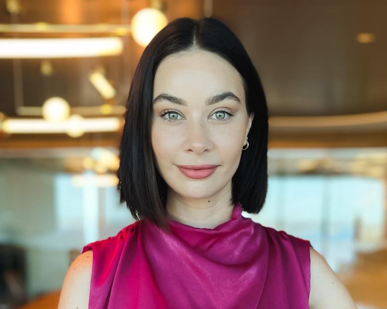 Professional headshot of woman in corporate attire.