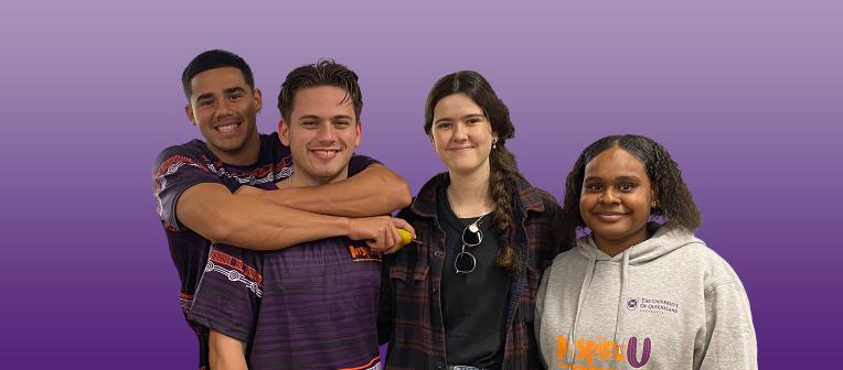 Four smiling UQ students