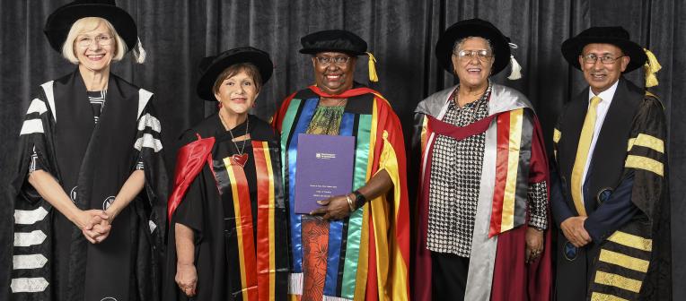 Aunty Ivy on stage with award