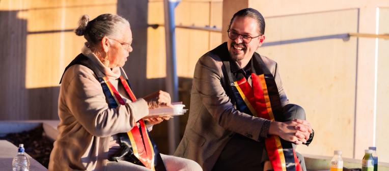 Two graduates at the 2025 mid-year Aboriginal and Torres Strait Islander sashing ceremony