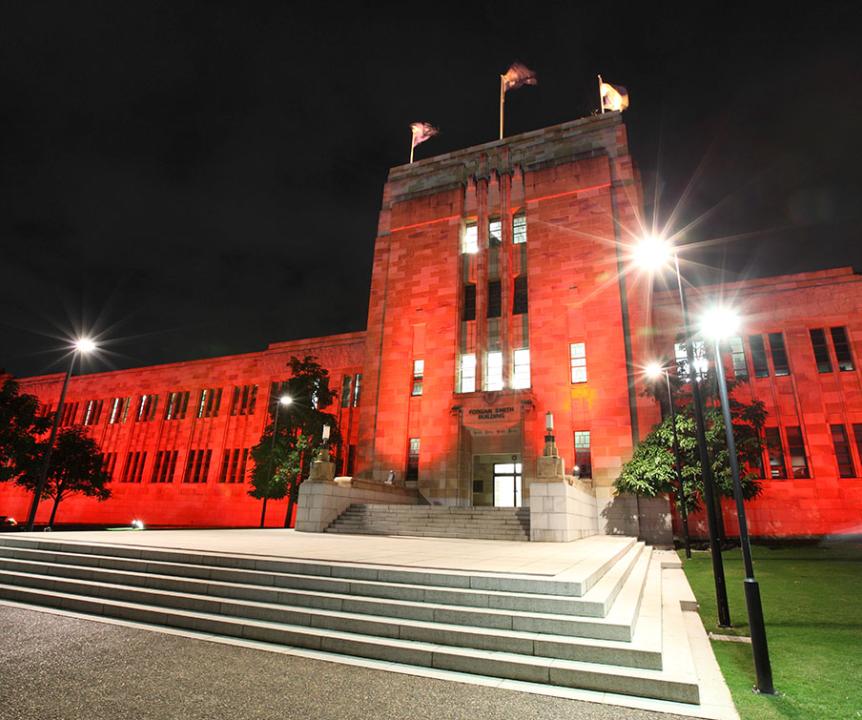 Forgan Smith building lit in red at night