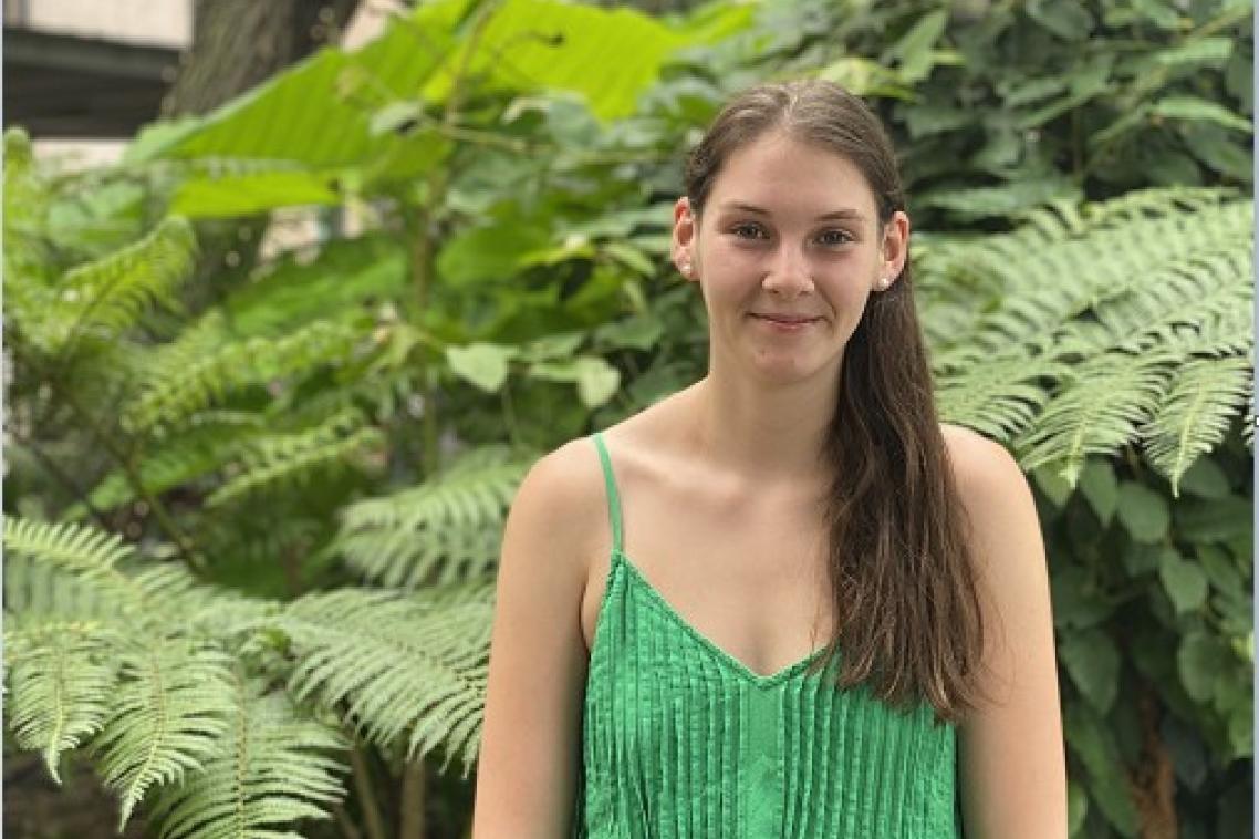 Miah Hickman smiling in front of garden