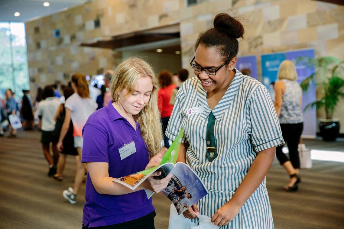 Two school students looking at brochure