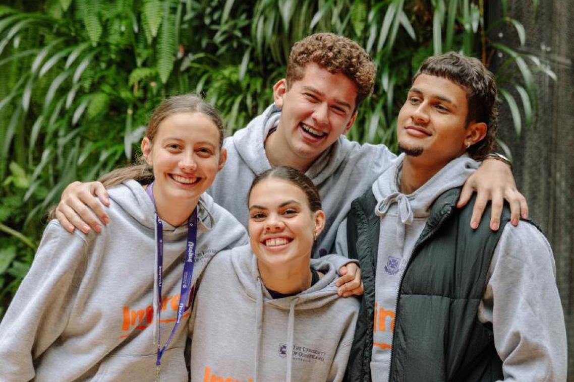 Four students smiling at camera. 