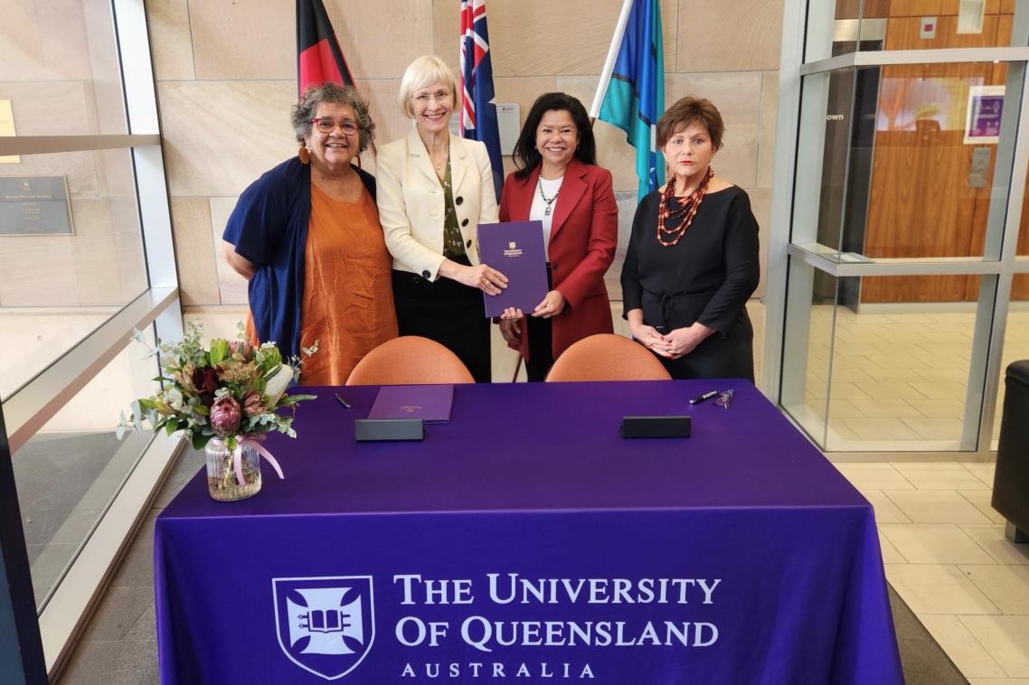 UQ VC, FNUniv President, UQ DVCIE, and UQ Professor of Indigenous Education pose holding signed MoU