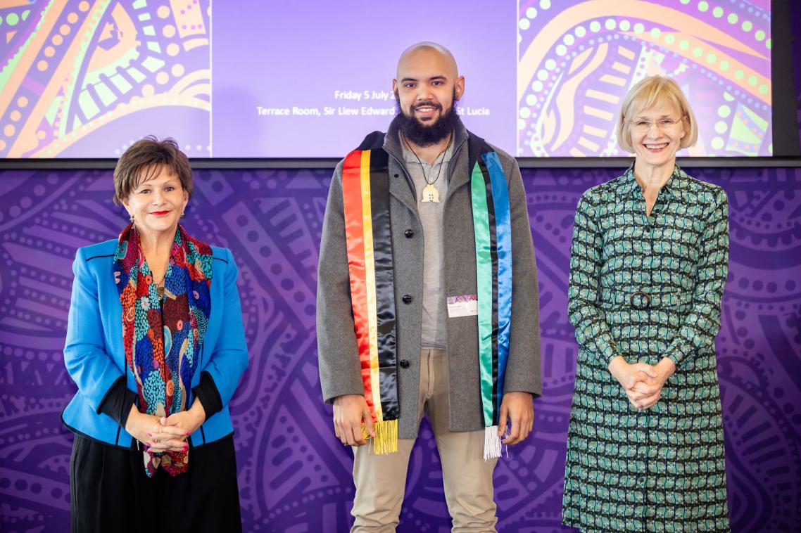 Elijah David standing with VC Prof Deborah Terry and DVCIE Prof Bronwyn