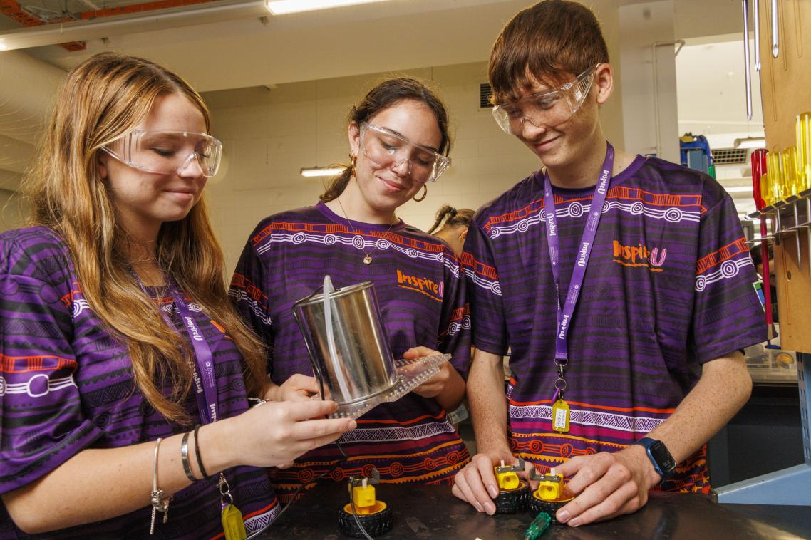 3 high school students participating in STEM activity at InspireU Camp