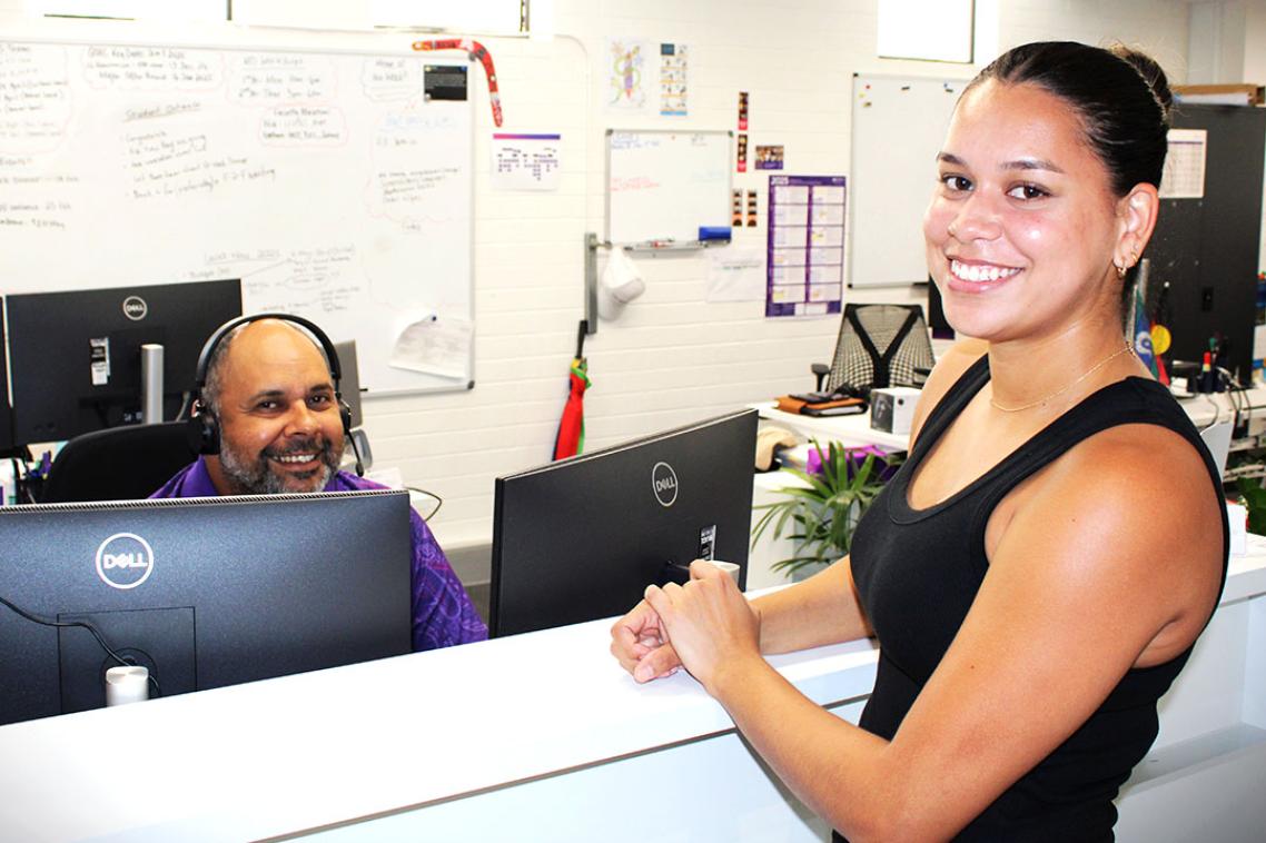 Student standing at ATSIS Unit reception desk